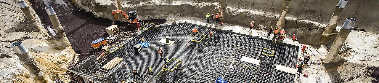 Building site showing reinforcing steel grid in foundation works